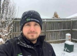 A Man Taking a Picture With a Snow Background